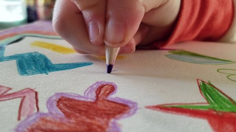 Child drawing with pencil crayons