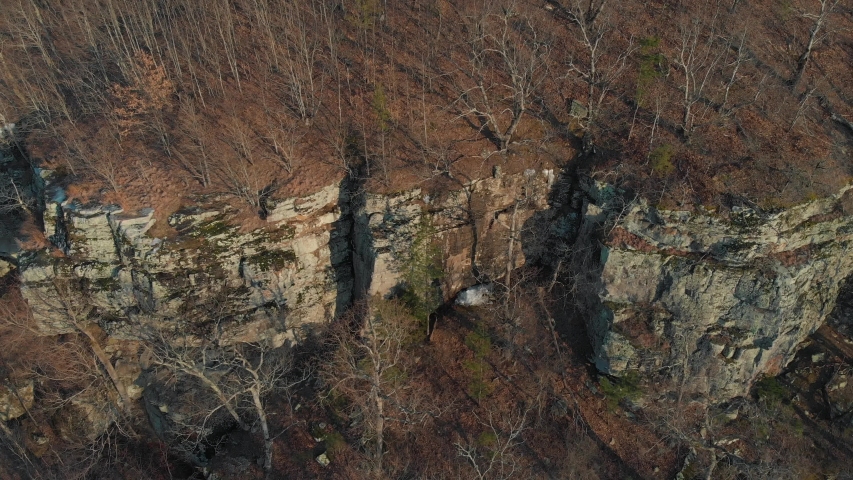 Aerial of Rock Bluff Cliffs in Forest. Stock footage.