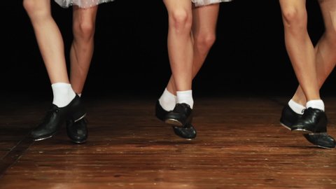 Children perform a dance step and dance. In a special black shoes with metal taps. Slow motion. Close-up.