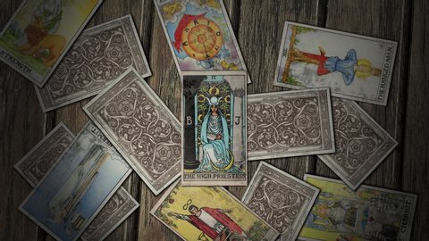 Bucharest, Romania - October 31, 2019: Camera Zoom to the Tarot Card of the High Priestess. Divination in Mysterious Place Deck Of Cards is on Floor in Chaos