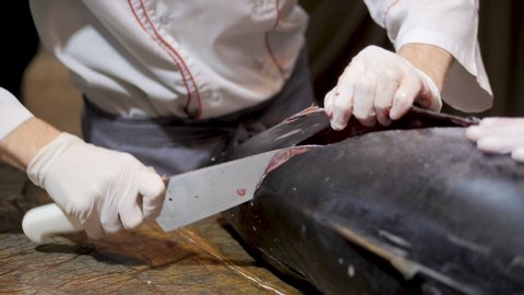 Chef cuts up a big Tuna fish in the restaurant