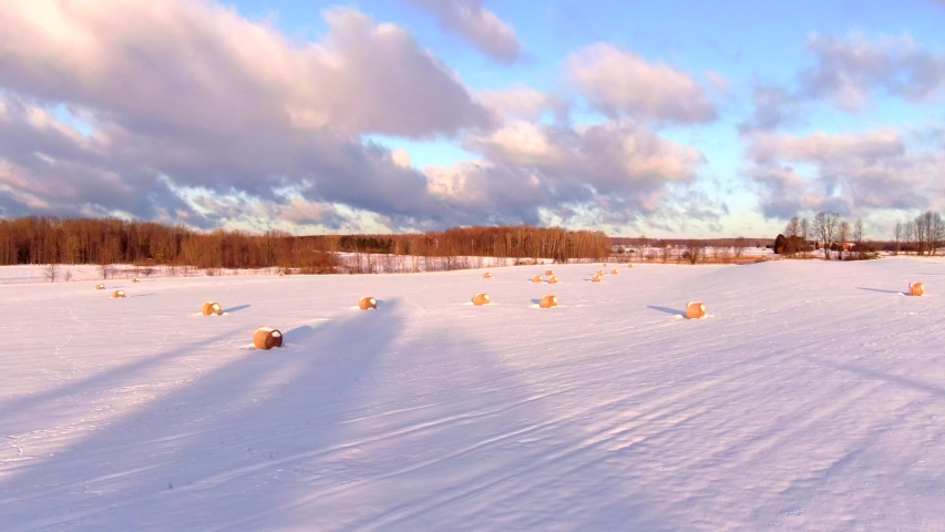 Stunning Wisconsin Winter rural landscape covered in fresh snow. Aerial view with long shadows at sunrise.