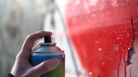 Woman Hand Using a Can of Spray Paint