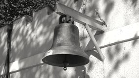 4K video shot of old school bell made of brass hanging on the big ring school wall Buy.