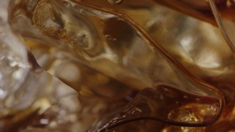 Filling up glass of ice with coffee macro shot, ice drink for morning, bubbles in drink, slow motion, shot on Red Weapon Helium 8k