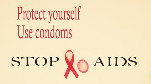 Stop AIDS. Protect yourself motivation quote appear with AIDS symbol and condoms on yellow background - Stop motion 