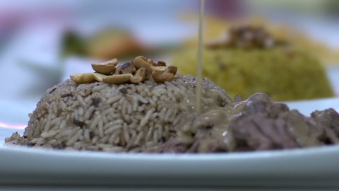 Pouring sauce on Kabsa plate, slow motion at 100 fps, Saudi cuisine
