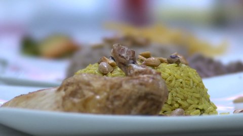 Putting chicken on Kabsa plate, Saudi cuisine, slow motion