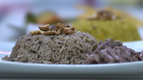 Dropping lamb meat on Kabsa plate, slow motion at 100 fps