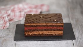 Close-up of the hands of a pastry chef decorates chocolate cake with gold leaf. - Powered by Shutterstock - Get 15% off with code: PIKWIZARD15