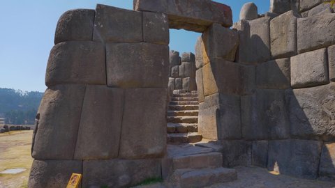 Ancient Inca gate to climb the old watchtower of the citadel of Sacsayhuaman. Fortification made base of large stone blocks carved and fit perfectly. Cusco City, Peru
