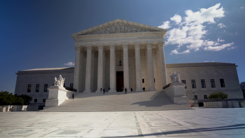 Wide camera motion to right of west facade of the Supreme Court building in Washington, DC. Royalty-Free Stock Footage #1043736949