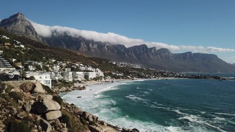 4K aerial summer sunny afternoon footage of spectacular scenic Clifton Beach, Lion's Head Mountain, cloudy Twelve Apostles in background, Atlantic Ocean coast in Western Cape, Cape Town, South Africa
