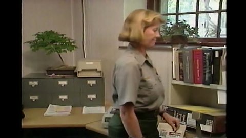 CIRCA 1990s - Police officers print pages and read and pull files and prepare for their surveillance in 1993.