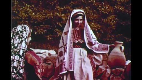 CIRCA 1950s - The fashion of Palestinian women is admired by the narrator as they talk and collect water together.