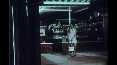 CIRCA 1970s - Two men stalk a woman walking alone at night, and assault her in a parking garage.