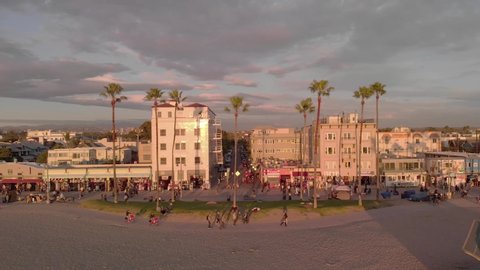 Los Angeles, CA/USA -   December 30, 2019: Aerial view of the famous Venice Beach boardwalk at sunset with sunlight reflecting off building windows