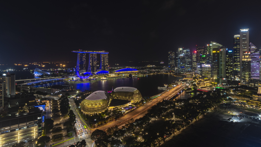 Beautiful Singapore Time lapse night view of Singapore city skyline from afar and high angle overlooking Marina Bay harbor view. Zoom out motion timelapse. Prores 4K Royalty-Free Stock Footage #1043766217