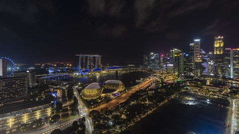 Beautiful Singapore Time lapse night view of Singapore city skyline from afar and high angle overlooking Marina Bay harbor view. Zoom out motion timelapse. Prores 4K