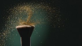 Glitter on a Make-up Brush Flying Away with Woman Finger Flicking Shot in Slow Motion on Green Aqua Menthe Color Background - Powered by Shutterstock - Get 15% off with code: PIKWIZARD15