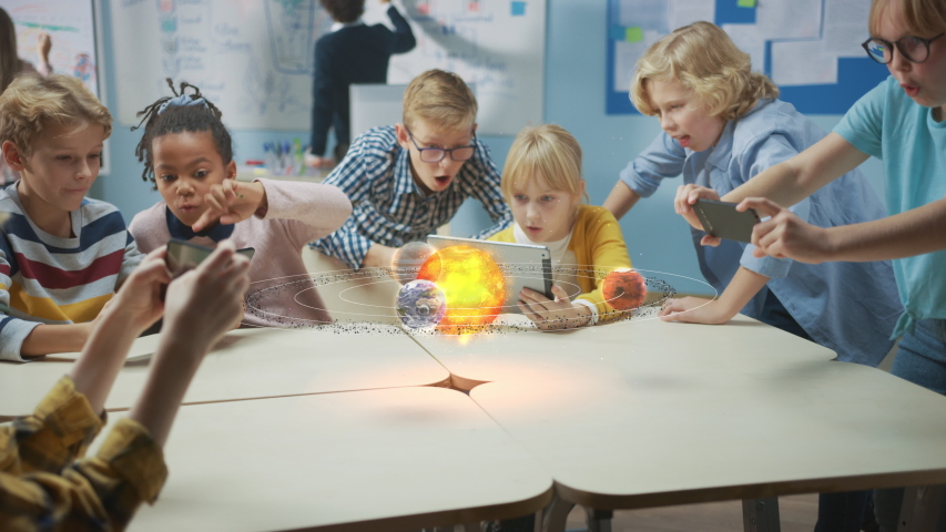Group of School Children in Science Class Use Digital Tablet Computers with Augmented Reality Software, Looking at Educational 3D Animation Of Solar System. VFX, Special Effects Render Royalty-Free Stock Footage #1043769193