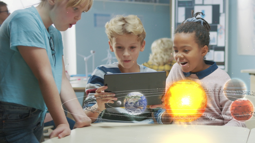 Three Diverse School Children in Science Class Use Digital Tablet Computer with Augmented Reality Software, Looking at Educational 3D Animation Of Solar System. VFX, Special Effects Render Royalty-Free Stock Footage #1043773123