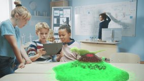 Three Diverse School Children Use Digital Tablet Computer with Augmented Reality Software, Looking at Educational 3D Animation - Dinosaur Walking on Island with Active Volcano. Special Effects FVX