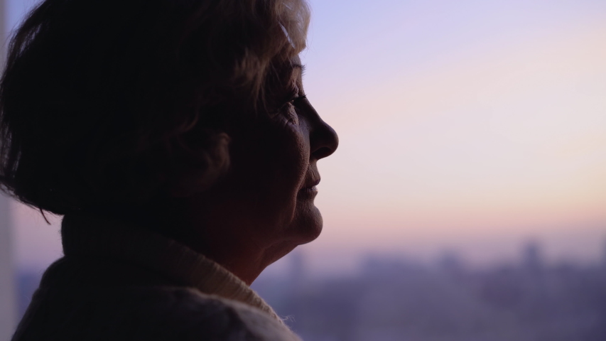 Unhappy wrinkled lady looking in window, suffering loneliness at senior age Royalty-Free Stock Footage #1043774272