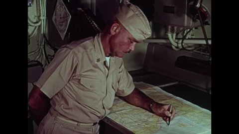 CIRCA 1964 - A US Naval Chief Quartermaster goes over a map of the Tonkin Gulf.