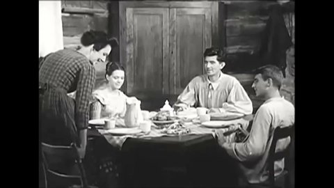 CIRCA 1950s - A family in the 1850s gathers around a dinner table while a narrator discusses how much harder they had in the past