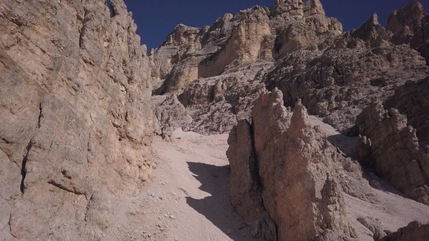 Drone aerial video flying on the special pinnacles of the dolomite rocks in the morning light, autumn season, in the Tofana area near Cortina D