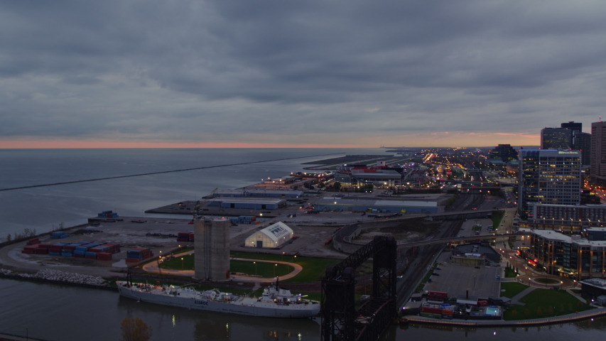 Cleveland Ohio Aerial Low to high panning industrial lakefront downtown cityscape at sunrise - October 2017 Royalty-Free Stock Footage #1043798629