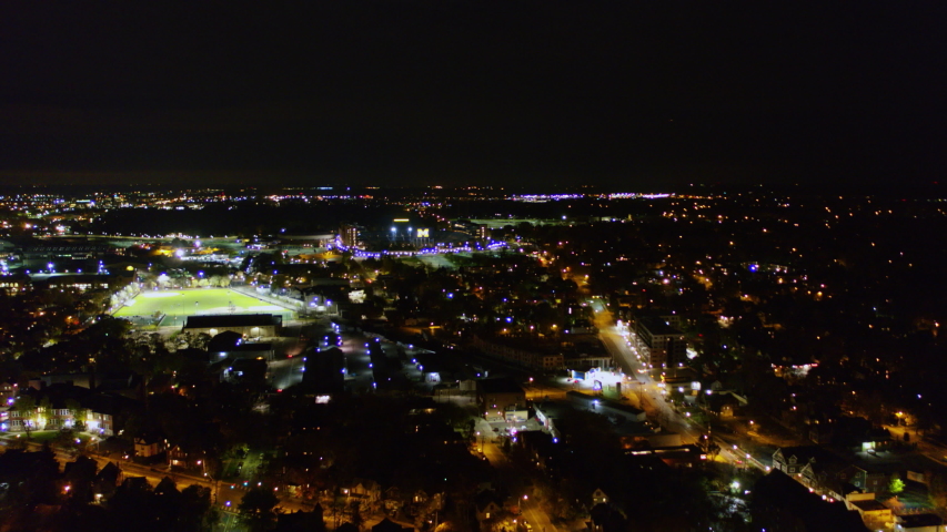 Ann Arbor Michigan Aerial Panning around Michigan sports field and stadium at night - October 2017