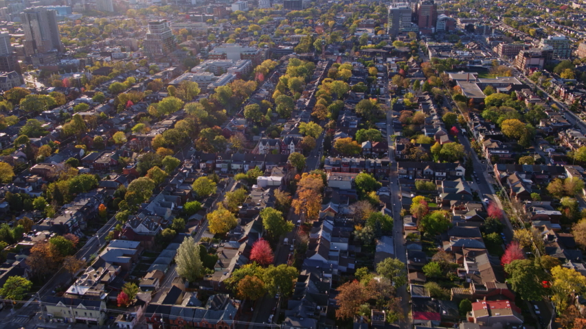 Toronto Ontario Aerial Flying in reverse birdseye, looking down and back at neighborhood streets panning up to view CityPlace and downtown skylines - October 2017