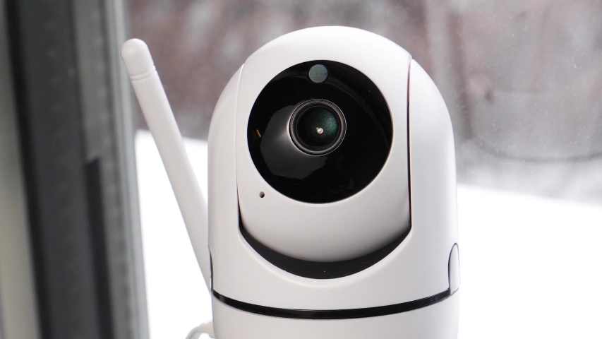 WiFi controlled home security camera moving filming around. Smart home surveillance system remotely operated. IP Internet CCTV cameras are a growing trend in a connected house. Royalty-Free Stock Footage #1043801476