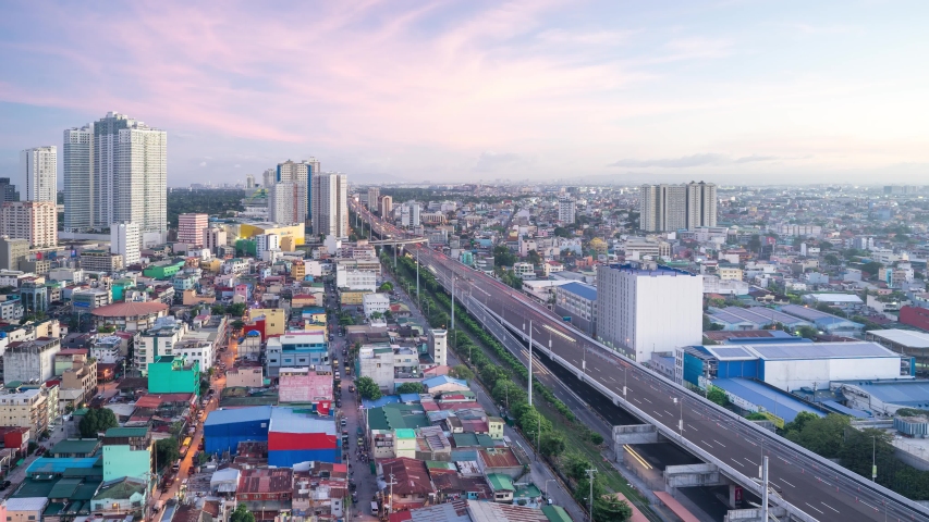 Makati city of Manila time-lapse from afternoon until evening showing light trail of cars on toll high way