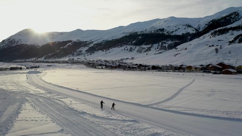 An aerial view of Livigno in winter - cross-country ski track in the winter at sunset - Livigno 12/12/2019
