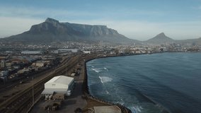4K high quality aerial sunny morning footage of industrial Transnet harbour, Table Mountain, busy highways, city center, Atlantic Ocean Table Bay panorama, Western Cape, Cape Town, South Africa