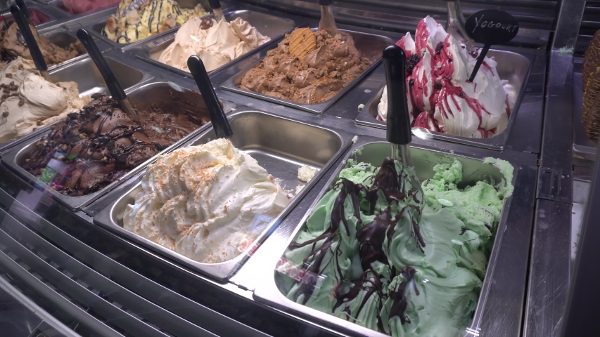 A beautiful background of ice cream. Around you can see the reflection of the people.