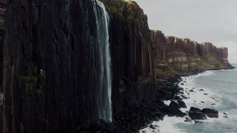 Mealt Falls on Kilt Rock, Isle of Skye, Scotland UK, Ascending Aerial. Natural Wonder of Scottish Island by North Sea