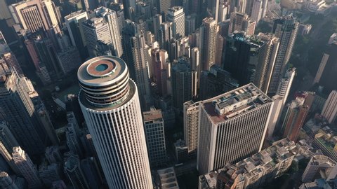 AERIAL. Cinematic video and Top view of Hong Kong city center at sunset and sun light.
