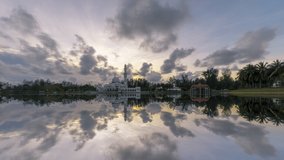 Beautiful Cloudy sunset Time Lapse at a floating Masjid Tengku Tengah Zaharah by a lake in Terengganu, Malaysia at dusk with fast clouds. Pan down motion timelapse. Full HD