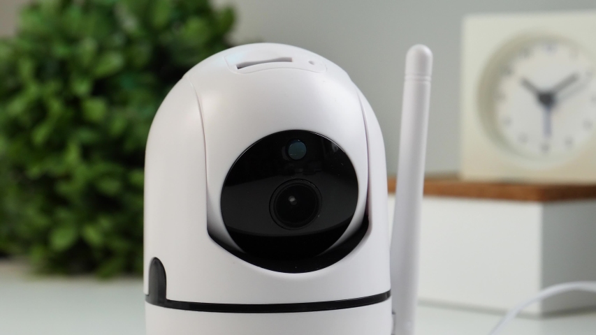 WiFi controlled home security camera moving filming around. Smart home surveillance system remotely operated. IP Internet CCTV cameras are a growing trend in a connected house. Royalty-Free Stock Footage #1043870260