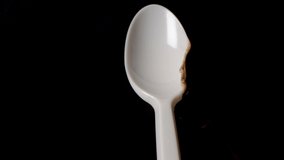 Flame melts plastic spoon in front of black background. Concept for global warming and sea pollution. - Powered by Shutterstock - Get 15% off with code: PIKWIZARD15