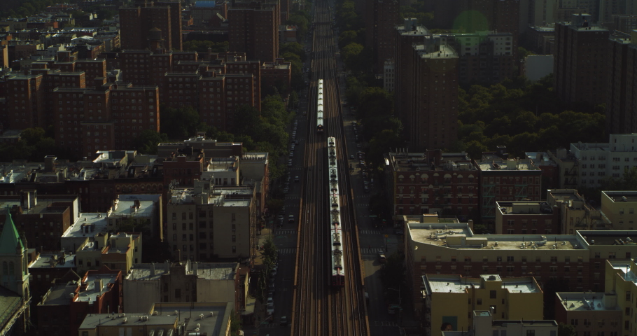 Aerial view city trains, buildings and skyscrapers in New York during the day under blue skies. Wide shot on 4K RED camera.