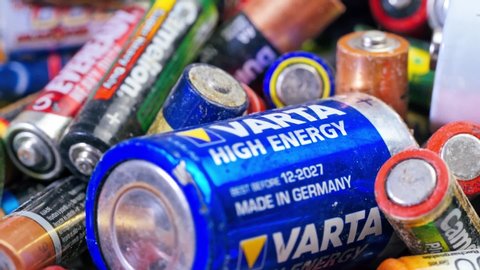VINNITSA, UKRAINE - September 2019: Used batteries from different manufacturers, waste, collection and recycling, high danger for the environment. Batteries background