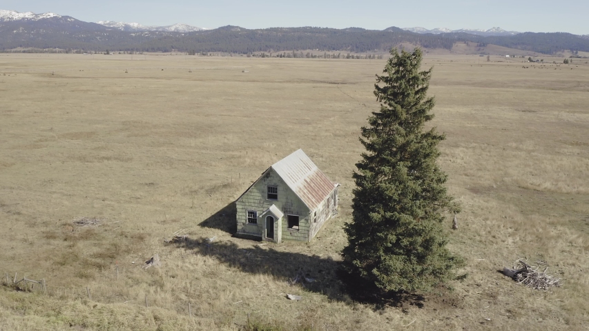 Aerial flying over an abandoned Haunted House on a farm. Donnelly, Idaho, USA 