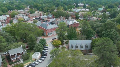 Aerial: Establishing shot of the town of the colonial town of Williamsburg. Virginia, USA. 10 August 2019 
