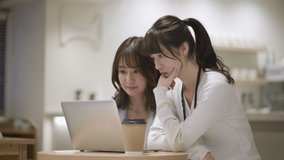 Two women working on laptops