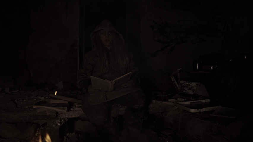 Homeless children bask in the ruins of a campfire. Apocalypse. War.